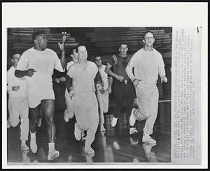 Preparing For Spring-- Operating on the theory that it’s a good idea to be in good shape for spring training, Stan Musial, star of the St. Louis baseball Cardinals, and other ball players are taking a pre-spring training series of workouts. Others in front row from left are Cardinal Bill White and Redbird trainer Bob Bauman. Musial, at right, says such workouts have added years to his playing career.