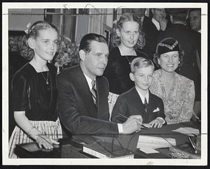 Massachusetts' First Family takes over the executive suite at the State House after Gov. Tobin's inauguration yesterday. Left to right, Carol Ann, the Governor, Helen Louise, Maurice, Jr., and Mrs. Tobin.