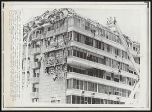 Search for Survivors--Firemen in a cherry picker search through wreckage of upper floors of an apartment house in Caraballeda, Venezuela, six miles north of Caracas, today. The building was damaged in a violent earthquake that struck Saturday. Five Americans are among the 58 knows killed in the quake.