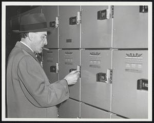 So. Station Lockers. Hal Neuhoff opens a locker that has run overtime