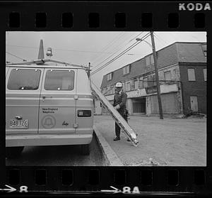 Man climbing pole near Customs House