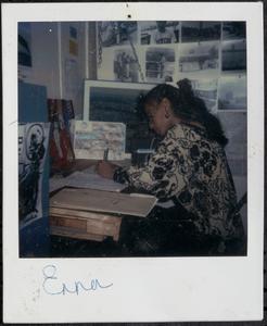 Teenage girl sitting at a desk and working