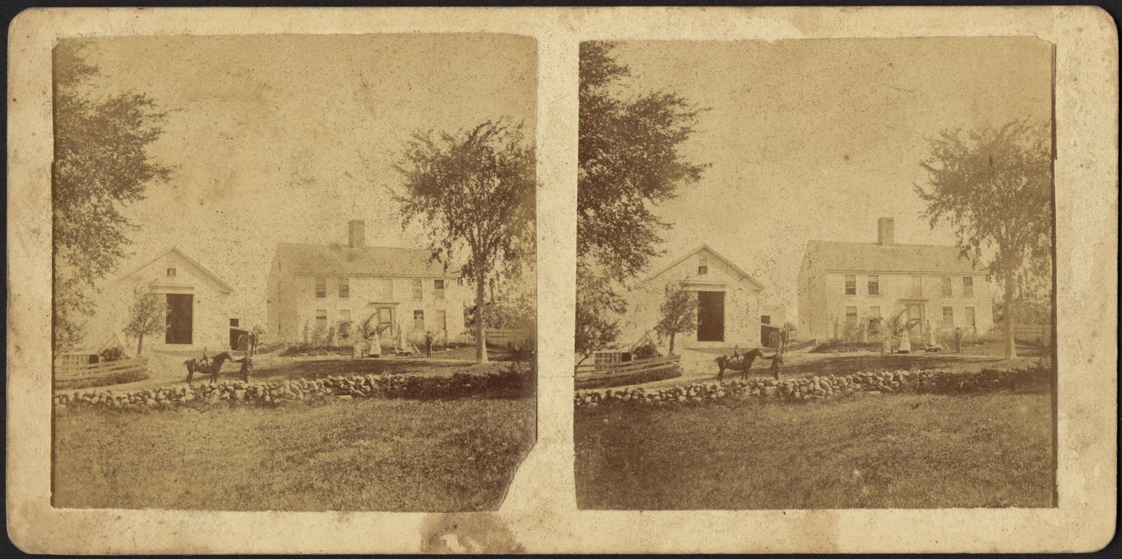 Unidentified family pictured with farmhouse, barn, and pasture