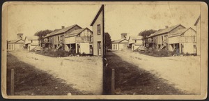 Rural town with unidentified men standing on a distant porch