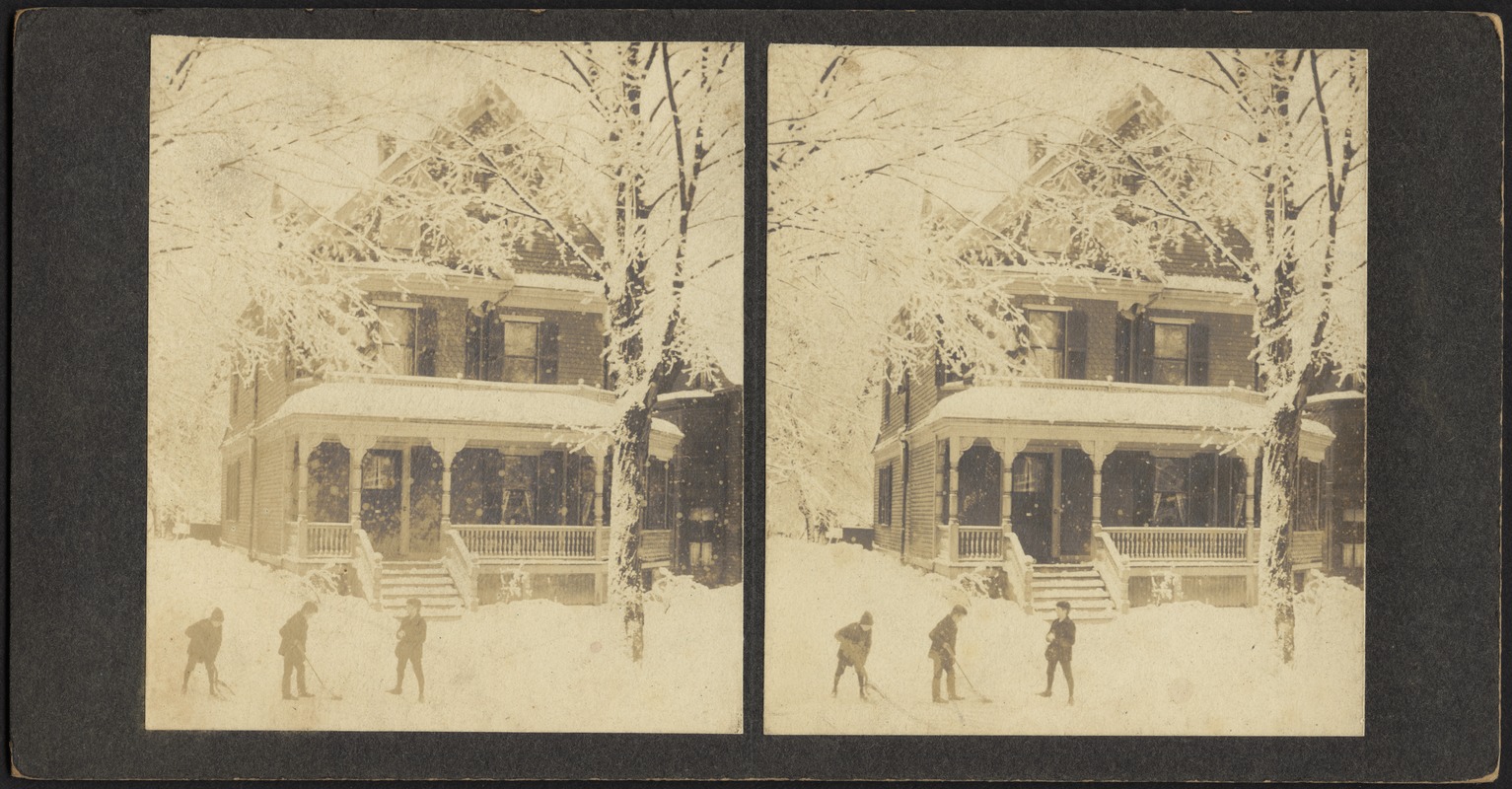 Children shoveling snow in front of house
