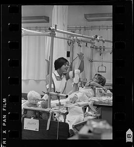 Mass. General Hospital student nurse cheers a young patient, Boston