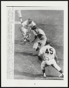 Houston Colt 45's Eddie Kasko (SS) is caught between Philadelphia Phillies Tony Taylor (2B) and Frank Thomas (1B) (45) during a third inning attempt by Kasko to stretch a hit into a double. Kasko was tagged out as he slid back into first during the 9/3 night action.