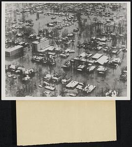 Paducah, KY., covered with water as seen from the air. Some 1,000 persons were trapped in their homes and a hotel. Twenty persons were known dead, including fourteen who drowned Jan. 25th when their rescue boat over-turned. Refugees were moved out by boat