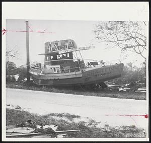 Roadside Docking--This fishing boat was literally plucked from the water by Hurricane Donna Friday night and dropped in an upended position on the side of a road near Tavernier, in Florida Keys.