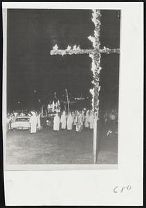 Klan Recruits in Alabama--Standing before burning crosses, Ku Klux Klan Imperial Wizard seeks new members among crowd of about 1,000 near Montgomery.