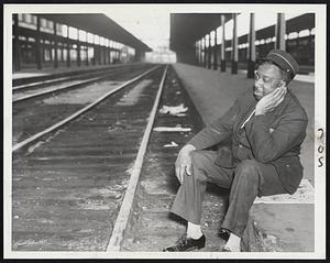 "I Been Workin' on the Railroad"--but that was once upon a time Redcap Charlie Hughes of Roxbury sits dejectedly alongside the South Station's deserted tracks and wonders how long the strike will last. He is but one of thousands throughout the country whose livelihood stopped when strike began.