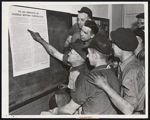 Workers in the Buick plant at Flint, Mich., reading a posted notice containing the statement of policy of Alfred P. Sloan Jr., president of General Motors Corporation, in which he refused to deal with the United Automobile Workers of America Union as the "sole" bargaining agency of the employes.