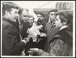 Jewish Students bearing a floral Star of David confront Symphony Hall officials. Svetlana Batsula, Soviet interpreter, is at right.