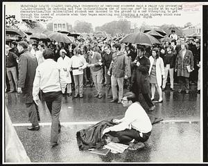University of Maryland students held a rally 5/4 protesting U.S. involvement in Cambodia and "the indiscriminate use of noxious gas" by police at an earlier demonstration. This unidentified student was knocked to the ground by a car attempting to get through the crowd of students when they began marching and blocking a major highway which runs through the campus.