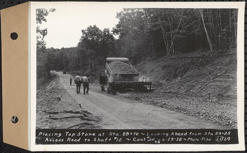 Contract No. 60, Access Roads to Shaft 12, Quabbin Aqueduct, Hardwick and Greenwich, placing top stone at Sta. 89+70, looking ahead from Sta. 89+25, Greenwich and Hardwick, Mass., Jun. 29, 1938