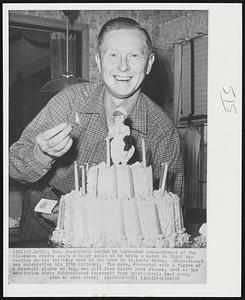 Another Candle on Cake -- Red Schoendienst of the Milwaukee Braves wears a happy smile as he holds a match to light the candles on his birthdaycake at his home in St. Louis today. Schoendienst was celebrating his 37th birthday. The cake, decorated with a figure of a baseball player on top, was a gift from his Sister Mary Jeanne, cook at the sanitarium where Schoendienst recovered from tuberculosis last year.