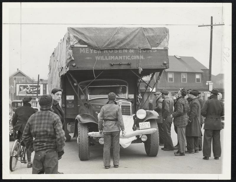 Trucking, with the exception of foodstuffs and a few other materials, was being stopped on all main roads leading into Rhode Island yesterday. Pickets are shown halting a truck at the Rhode Island-Massachusetts state line at Pawtucket.