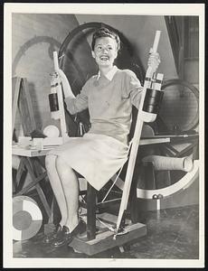 This Private merry-go-round demonstrates how distribution of weight affects the speed of a whirling body. The swivel chair is set in motion by a gentle push and as the occupant pulls the weighted levers toward her, the rate of rotation increases sharply.