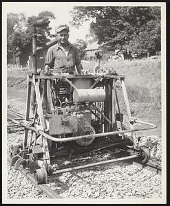 "Tracks lifter" which raises sections of tracks hydraulically to enable workmen to lay crush stone under ties Machinery