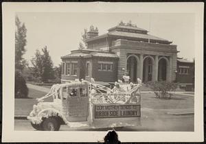 Parade decorated truck in front of Lawrence Library