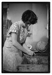 Woman doing laundry at a sink