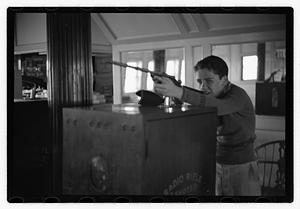 Boy with a toy gun on a ship