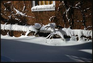 Bicycle in deep snow next to brick building