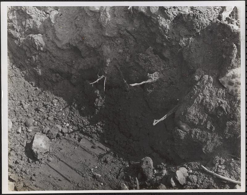 Test pit on spillway side of dam, downstream area