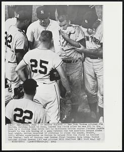 Bouton Blasted -- New York Yankee pitcher Jim Bouton, holding towel to face, leaves the field after he was hit in the face by a vicious line drive hit by Baltimore Oriole center fielder Jackie Brandt in the 4th inning of a game between the two American League clubs last night. Bouton required 12 stitches to close the wound. Brandt, (25), offers condolences as Bouton, and Yankee first baseman Dale Long, Yankee catcher Elston Howard (32) and pitcher Bill Stafford (22) look on.