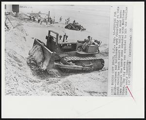 Prepare for Diane -- Workmen and bulldozers work feverishly at this South Carolina beach resort to build new sand barriers against the heavy seas expected with Hurricane Diane. The big storm was expected to hit the Carolina coast early tomorrow.