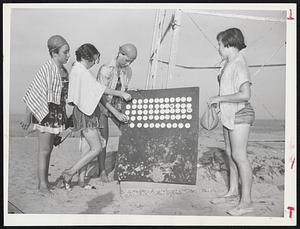No Chance of Losing a Swimmer is taken at the Essex County polio camp on Plum Island where children must mark their whereabouts with tags. Replacing their markers after a swim are Martha Rowe of Marlboro, Elaine Roche of North Andover, Sylvia Woodworth of Nahant and Sandora Coots of Brockton.