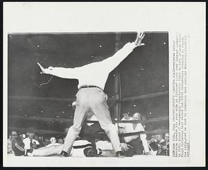 Patterson's Champion Again--Referee Arthur Mercante spreads his arms wide as finishes count over Ingemar Johansson in fifth round of heavyweight championship fight in Polo Grounds tonight Floyd Patterson thus became the first heavyweight champion to retain the title, that he lost to Johansson last year.
