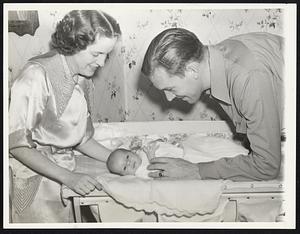 Blondy's Valentine' Mr. and Mrs. John C. Ryan--he's better known as "Blondy" to baseball fans in New York, where he infields for the Giants--look fondly on two-weeks-old Joan Kathleen, who moved from the hospital into the Ryan home at Lynn, Mass., Feb. 13, just in time to be her father's Valentine. They are shown Feb. 14.