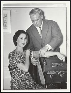 Pretty Edna Cushing hears the voice of conscience as Dr. Marston applies the arm band which will measure her blood pressure.