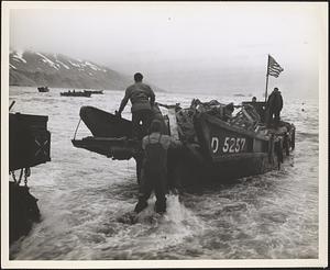 Americans bring ashore a captured [Japanese] landing boat at Attu