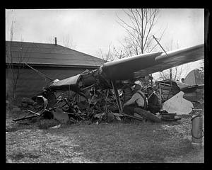 People examining a wrecked airplane