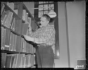 Student in the stacks of the Marsh Memorial Library