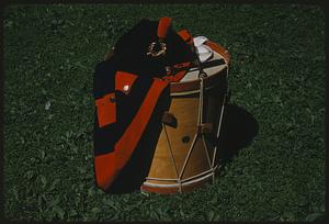 Drum and marching band uniform coat on grass, Boston