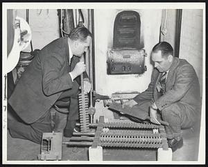 WPB Head Converts from oil to coal. Walter H. Wheeler, Jr (left), New England director of the War Production Board, has his oil burner converted at his home, 32 Lime street. James De Wolfe (ight), supervises the job, which was completed between breakfast and dinner.