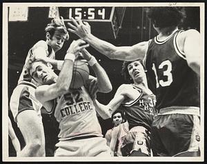 Get That Ball!-Pete Schmid (52) of Boston College collides with teammate while getting rebound in victory over Harvard in final of Beanpot tourney at Garden. Harvard players are Tom Mustoe (13) and Hal Calbom (30).