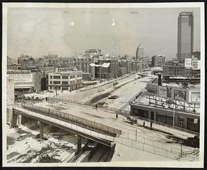 Over the toll road & extension and the tracks of the Boston-Albany Railroad.