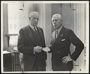 Mayor Mansfield, left, enrolled in the Red Cross, presents his check to Edward A. Taft, roll call chairman of the Boston Metropolitan chapter.