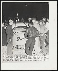 Armed Indians talk to man believed to be klansman before light bulb was shot out that started gun battle between klansmen and Indians last night at Maxton.