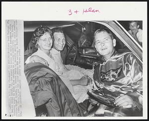 Ready for Honeymoon--James Earl Taylor, 27, Bessie Irene Tyson, 37, are ready to leave on their honeymoon after Saturday night Ku Klux Klan wedding in a dusty cornfield. The North Carolina Grand Dragon, J. Robert Jones of Granite Quarry is still wearing is robe. Theirs was the first public KKK wedding in North Carolina since 926.