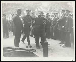 Striker Arrested in Textile Disorder in Lawrence. Scenes such as the above were common in Lawrence, Mass., on Oct. 7, when police broke up demonstrations of textile strikers. More than 20,000 Lawrence workers left their work in protest against a 10 percent wage cut due to become effective on Oct. 12.