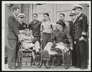 Gov. Tobin greets Vets at Chelsea in conjunction with VE Day celebration held at Chelsea Naval Hospital. Photo shows Tobin shaking hands with S/1c William A. McNamara, while Pfc. Ashley O. Dodge of the Marine Corps grins. Rear row (left to right): Rear Admiral W.D. Baker, commandant Naval Base, Boston; S/1c Charles Thompson; S/1c James O’Rourke, S/1c Earl Dennis; Capt. Frederic R. Hook, MC, USN, and Rear Admiral M. L. Deyo, USN. (Story on Page 37).