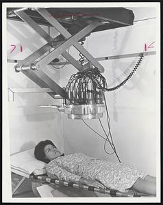 Mrs. Betty Dorsey is shown facing the whole body counter at Winchester Lab. This device detects and measures radiation levels so low that even natural radiation must be blocked.