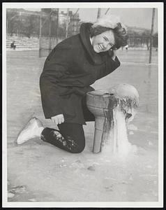 Mary M. Sherry, 121 Harodan Way, Roxbury, gets a drink from the bubbler at the flooded for skating Fenway Stadium Ballfield