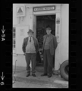 Two men standing at door of H. Verne Noyes' Citgo station