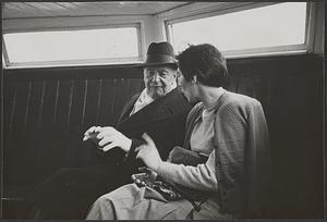 Serge Koussevitzky seated next to an unidentified woman on a boat